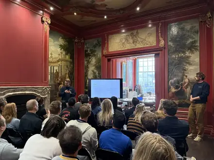Participants watching a live demonstration on screen