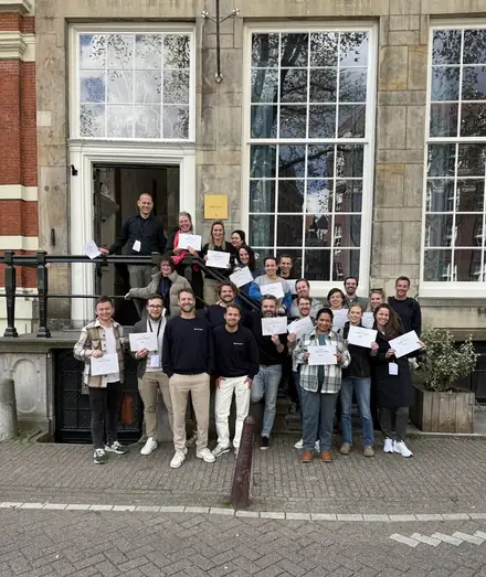 Participants standing outside with their certificates