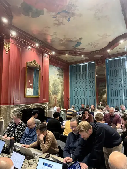 A room of participants working on open laptops