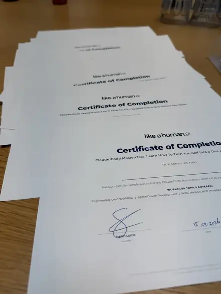 A stack of printed and signed certificates on a table