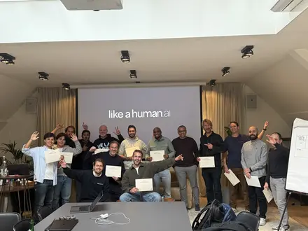 A full group cheering with their certificates in the workshop room